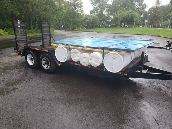 The boat loaded on a trailer. The boat’s deck is the color of weezer’s debut album. Everything is covered in rain