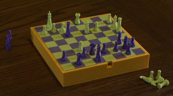 two player chess on top of the box with the 8 by 8 board face up on top